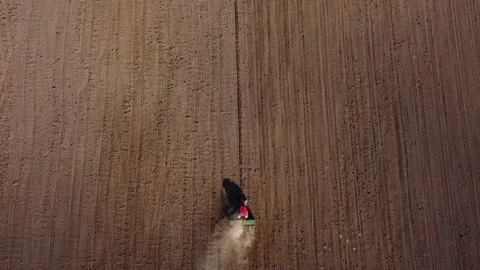 Top view from a drone of a tractor plowing and sowing ground Stock Footage 241018080