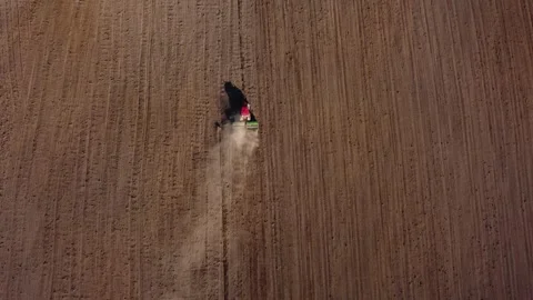Top view from a drone of a tractor plowing and sowing ground Stock Footage 241018363