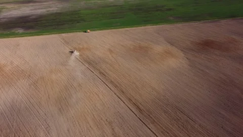 Top view from a drone of a tractor plowing and sowing ground Stock Footage 241019284