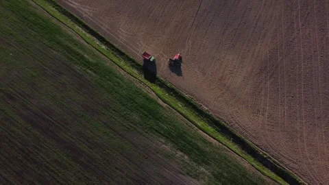 Top view from a drone of a tractor plowing and sowing ground Stock Footage 241019574
