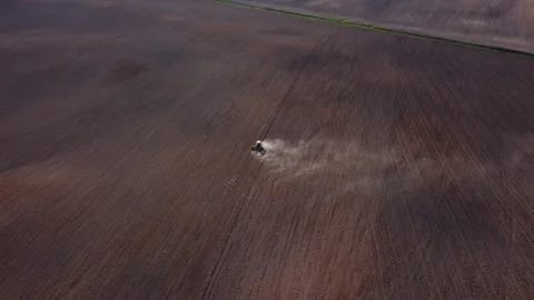 Top view from a drone of a tractor plowing and sowing ground Stock Footage 241019780