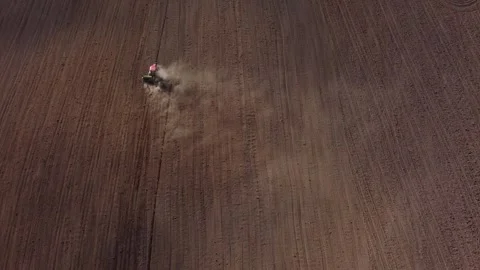 Top view from a drone of a tractor plowing and sowing ground Stock Footage 241020041