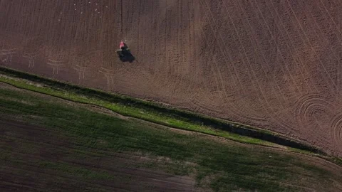 Top view from a drone of a tractor plowing and sowing ground Stock Footage 241020190