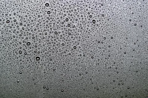 Top view of droplets on dark background Stock Photos