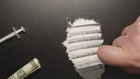 TOP VIEW: Drugs - Man does a lines of heroin by plastic card Stock Footage 72970267