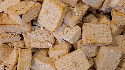 Top view of dry tofu blocks waste at a food production factory. Video stock 330972431