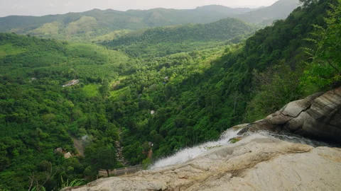 Top view of dynamic waterfall cascading into tropical forest valley. Rapid water Stock Footage 274433386