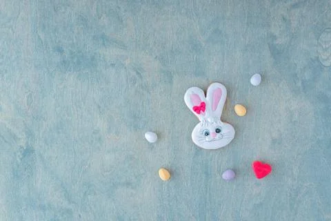 Top view of Easter bunny with chocolate eggs and red heart on wooden green .. Stock Photos