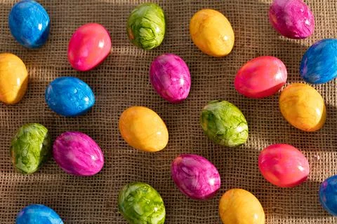 Top view of Easter eggs arranged randomly side by side on linen fabric. Easter. 写真素材