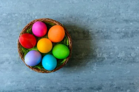 Top view of Easter eggs in a basket on concrete background Stock Photos