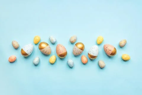 Top view of easter eggs colored with golden paint and differen colors. Blue.. Stock Photos