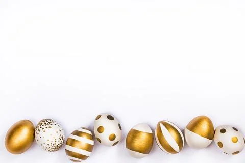 Top view of easter eggs colored with golden paint in differen patterns. Var.. Stock Photos