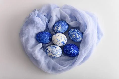 Top view of Easter eggs in fabric nest in the color of the year-classic blue Stock Photos