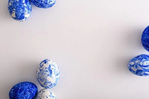 Top view Easter eggs in white and classic blue on white background Stock Photos