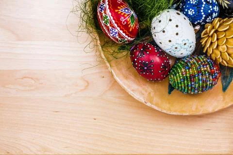 Top view of easter eggs in wooden bowl on wooden backgroud Stock Photos