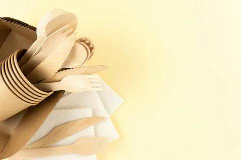 Top view of eco tableware on a beige background with copy space. Stock Photos