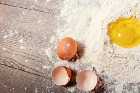 The top view of an egg, beaten into flour, cooking dough against the backgrou Stock Photos
