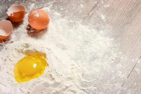 The top view of an egg, beaten into flour, cooking dough against the backgrou Stock Photos