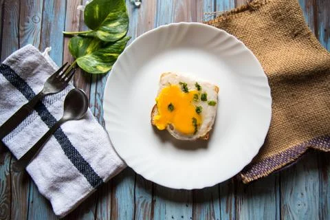 Top view of egg poach on bread in a white plate Stock Photos