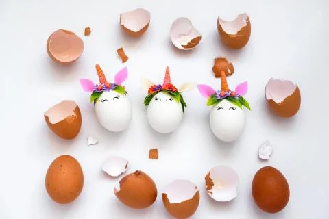 Top view egg shell and Easter unicorn eggs pattern on a white background Stock Photos