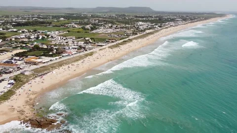 Top view of El Palmar beach in Vejer de la Frontera with surfers Stock Footage 240045651