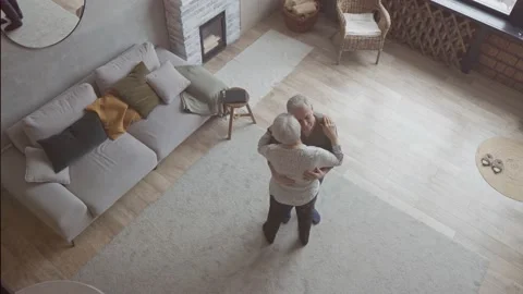 Top view of an elderly couple dancing in the living room Stock Footage 172528979