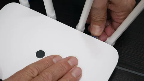 Top View Elderly Man Hand Unplugging Blue Internet Cable From Wireless Router. Stock Footage 119663006