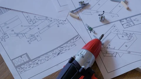 Top view of electric powered screwdriver, screws and Instructions Stock Footage 108727205