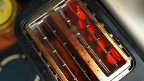 Top view of an electric toaster heating with glowing red coils, showing Stock Footage 330848347