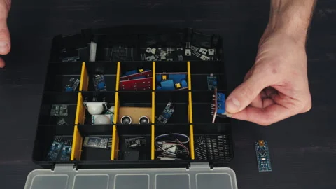 Top-View Electronics: Hands Sorting and Inspecting Electrocomponents in Stock Footage 246732022