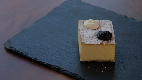 Top view of an elegant square piece of cheesecake 스톡 동영상 168189466