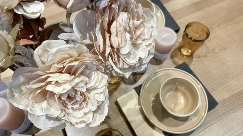 Top view of an elegant table setting with beige ceramic plates, amber glass.. Stock Photos