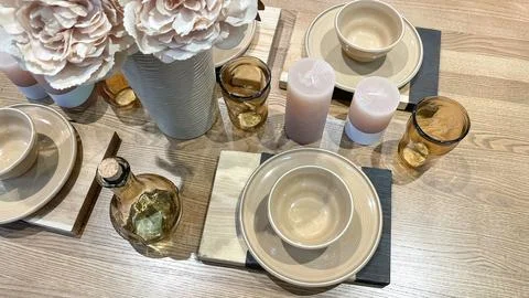 Top view of an elegant table setting with beige ceramic plates, amber glass.. Stock Photos