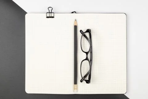 Top view of an emptry grid notebook with pencil and eyeglasses Stock Photos