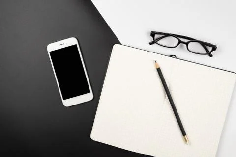 Top view of an emptry grid notebook with pencil and smartphone Stock Photos