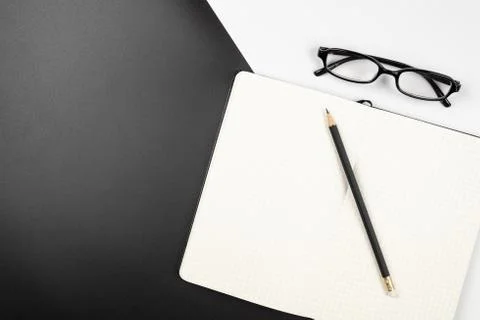 Top view of an emptry grid notebook with pencil and eyeglasses Stock Photos