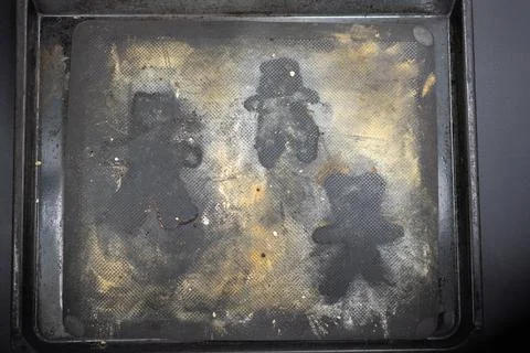 Top view of empty baking sheet with shape of Grittibnz. Stock Photos