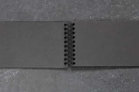 Top view on the empty black notepad on the black table. Copy space. Stock Photos