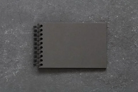 Top view on the empty black notepad on the black table. Copy space. Stock-Fotos