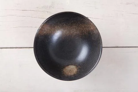 Top view of empty black plate put on white wood table with space for copy. Stock Photos