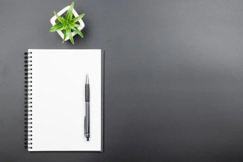 Top view of empty blank notebook with pen on black background Stock Photos