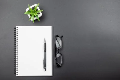 Top view of empty blank notebook with pen on black background Stock Photos
