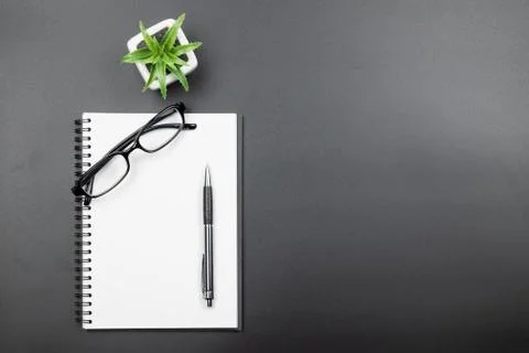 Top view of empty blank notebook with pen on black background Stock Photos