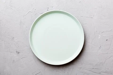 Top view of empty blue plate on cement background. Empty space for your desig Stock Photos