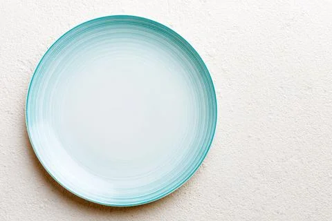 Top view of empty blue plate on cement background. Empty space for your desig Stock Photos