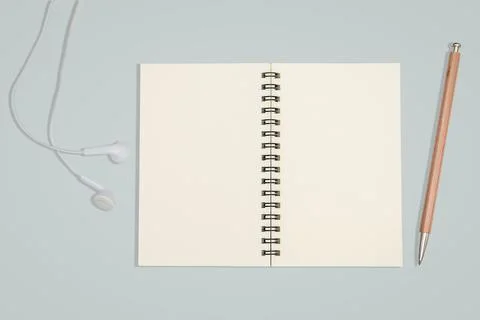 Top view- a empty book spread and  earphone isolated on blue background Foto stock
