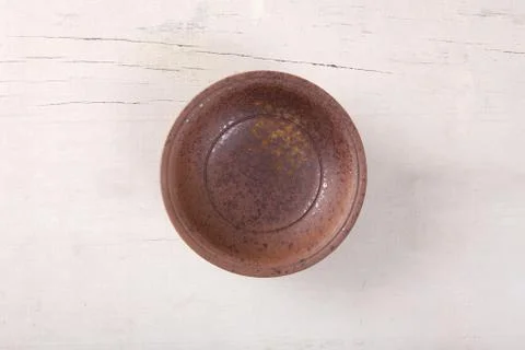 Top view of empty brown plate put on white wood table with space for copy. Stock Photos