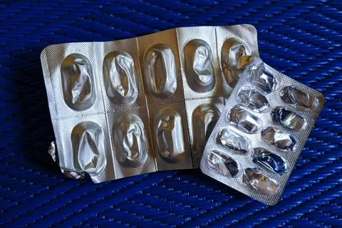 Top view of empty capsule strips isolated on blue background mat Stock Photos
