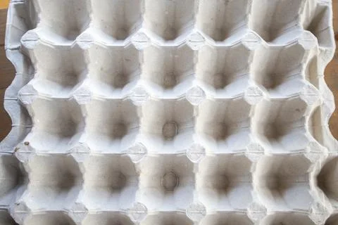Top view of an empty cardboard egg tray. Background texture of a container made Stock Photos