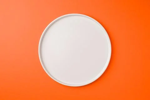 Top view of empty ceramic white plate on blue background 스톡 사진
